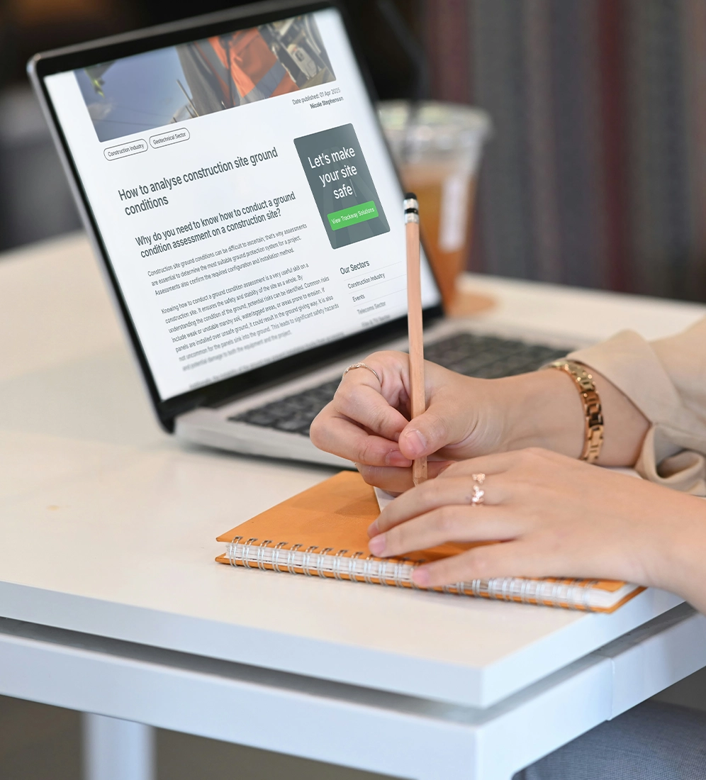 writing notes next to laptop